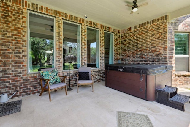 view of patio / terrace featuring a hot tub and ceiling fan
