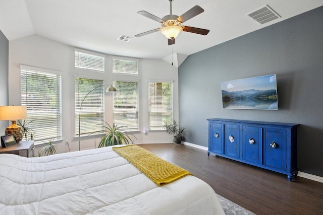 bedroom featuring lofted ceiling, visible vents, and dark wood-type flooring