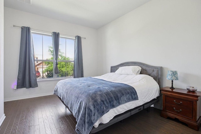 bedroom with hardwood / wood-style floors and baseboards
