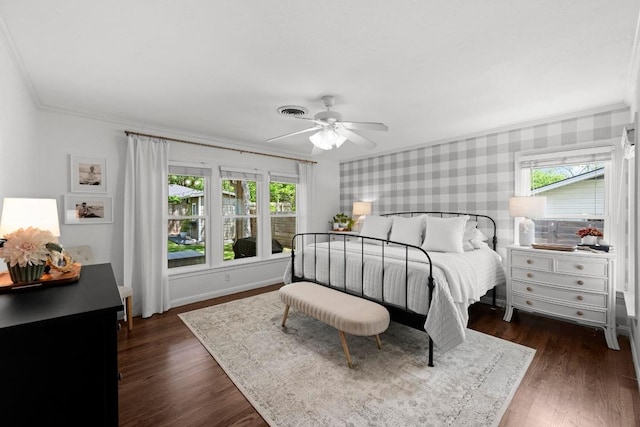 1403 E 16th St, Georgetown, TX 78626 - bedroom featuring wallpapered walls, crown molding, dark wood-style flooring, a ceiling fan, and baseboards