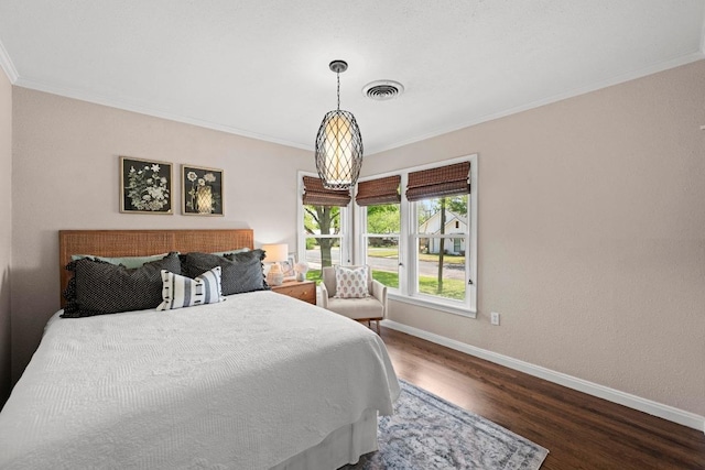 1403 E 16th St, Georgetown, TX 78626 - bedroom featuring baseboards, wood finished floors, and crown molding
