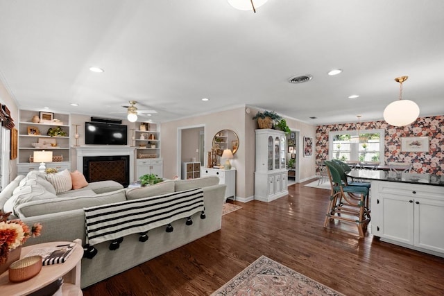 1403 E 16th St, Georgetown, TX 78626 - living area with a fireplace, a ceiling fan, recessed lighting, crown molding, and baseboards