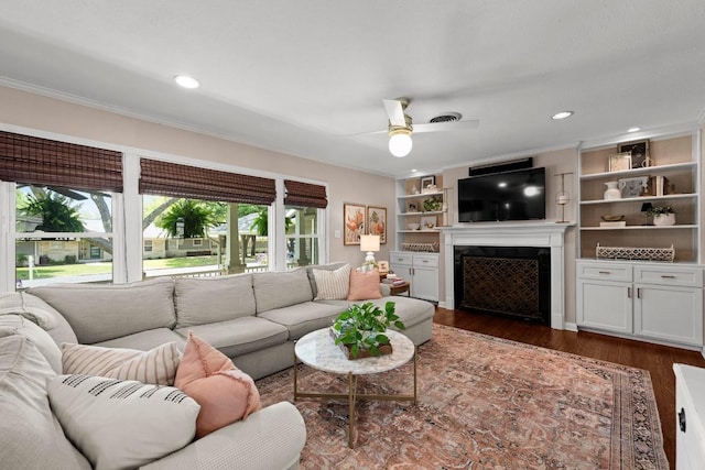 1403 E 16th St, Georgetown, TX 78626 - living room with a fireplace, dark wood finished floors, a ceiling fan, crown molding, and recessed lighting