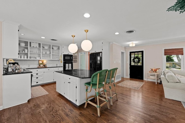 1403 E 16th St, Georgetown, TX 78626 - kitchen featuring black appliances, dark countertops, open shelves, dark wood finished floors, and white cabinetry