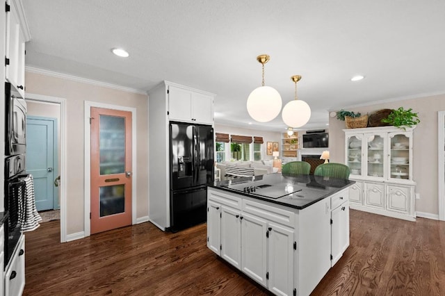1403 E 16th St, Georgetown, TX 78626 - kitchen with black appliances, dark countertops, white cabinets, ornamental molding, and dark wood-style flooring