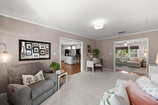 1403 E 16th St, Georgetown, TX 78626 - living area featuring carpet floors, crown molding, baseboards, and a ceiling fan