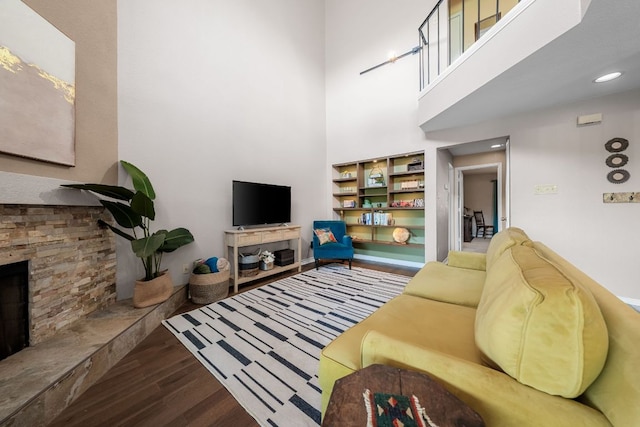 8200 Neely Dr Unit 217, Austin, TX 78759 - living room featuring wood finished floors, a stone fireplace, and a towering ceiling
