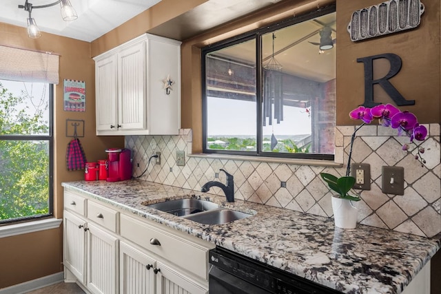8200 Neely Dr Unit 217, Austin, TX 78759 - kitchen with a sink, decorative backsplash, black dishwasher, white cabinetry, and light stone counters