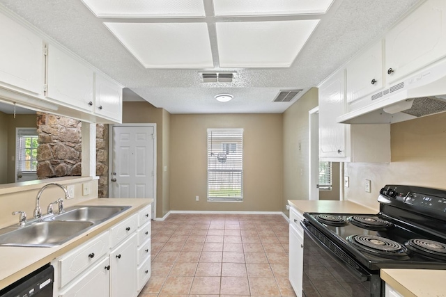 kitchen with under cabinet range hood, visible vents, a sink, and black appliances