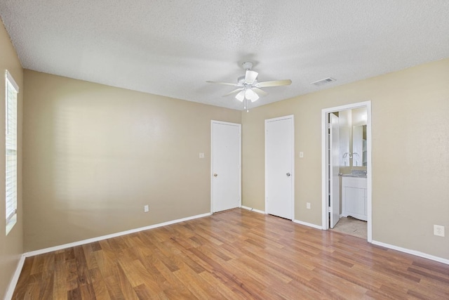 unfurnished bedroom with baseboards, visible vents, and light wood-style flooring