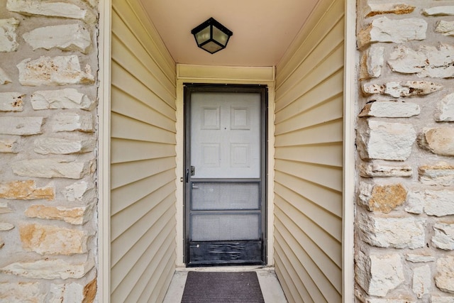 607 Elderberry Cv, Austin, TX 78745 - doorway to property featuring stone siding