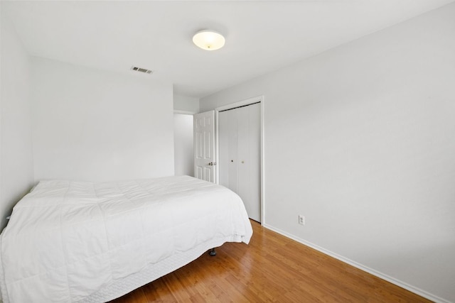 607 Elderberry Cv, Austin, TX 78745 - bedroom featuring baseboards, wood finished floors, and a closet