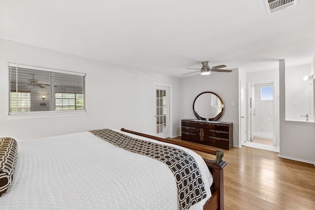607 Elderberry Cv, Austin, TX 78745 - bedroom featuring light wood-style floors, baseboards, ceiling fan, and connected bathroom
