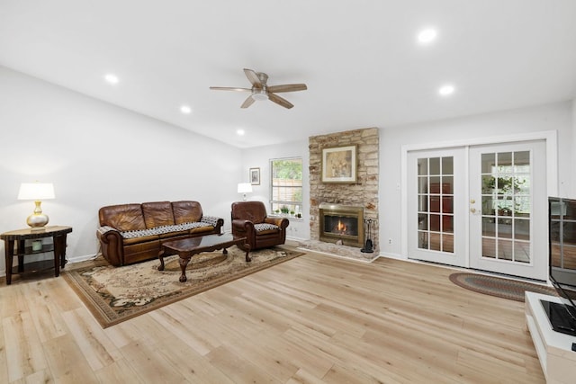 607 Elderberry Cv, Austin, TX 78745 - living room with a ceiling fan, french doors, wood finished floors, a stone fireplace, and recessed lighting