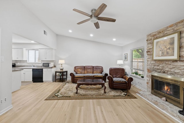 607 Elderberry Cv, Austin, TX 78745 - living room with light wood-type flooring, ceiling fan, a fireplace, recessed lighting, and vaulted ceiling