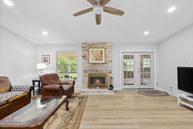 607 Elderberry Cv, Austin, TX 78745 - living room with french doors, light wood-style floors, recessed lighting, ceiling fan, and a stone fireplace