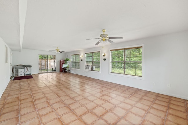 607 Elderberry Cv, Austin, TX 78745 - unfurnished living room featuring a ceiling fan and a wood stove