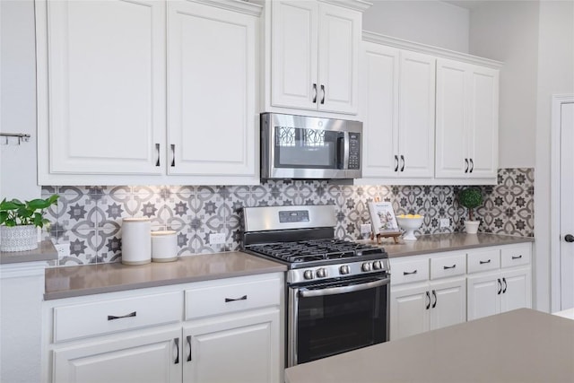 505 Saturnia Dr, Georgetown, TX 78628 - kitchen featuring appliances with stainless steel finishes, backsplash, and white cabinetry