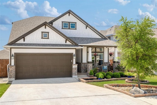 505 Saturnia Dr, Georgetown, TX 78628 - craftsman-style house featuring a porch, driveway, roof with shingles, a garage, and brick siding