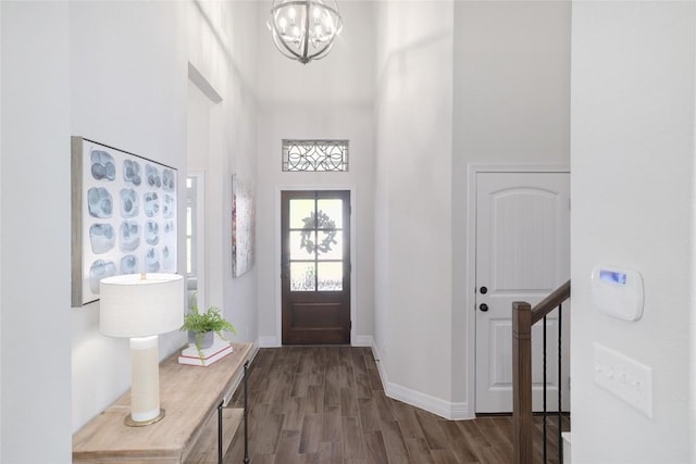 505 Saturnia Dr, Georgetown, TX 78628 - entrance foyer featuring a towering ceiling, dark wood-style floors, a chandelier, and baseboards