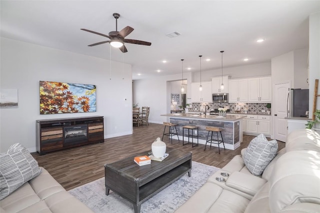 505 Saturnia Dr, Georgetown, TX 78628 - living room with dark wood-style floors, a ceiling fan, recessed lighting, and baseboards