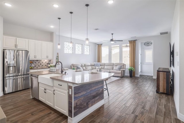 505 Saturnia Dr, Georgetown, TX 78628 - kitchen with appliances with stainless steel finishes, dark wood finished floors, white cabinets, and recessed lighting