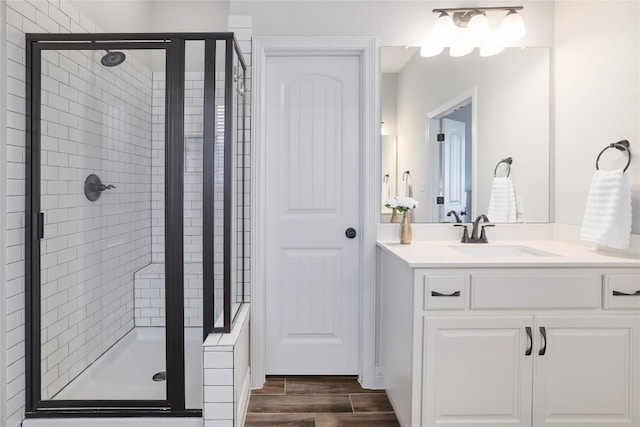 505 Saturnia Dr, Georgetown, TX 78628 - bathroom featuring a stall shower, vanity, and wood finished floors