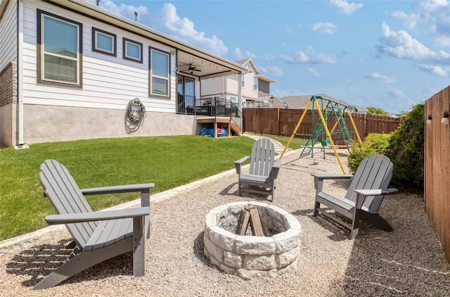 505 Saturnia Dr, Georgetown, TX 78628 - fenced backyard with a fire pit and a playground