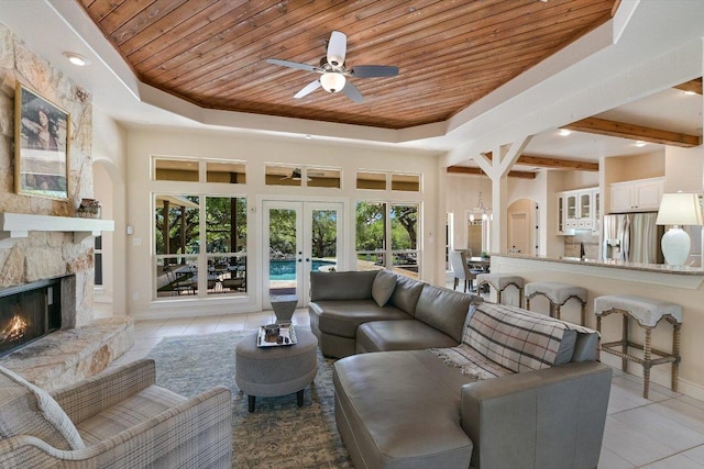 living room with wood ceiling, french doors, a fireplace, and ceiling fan
