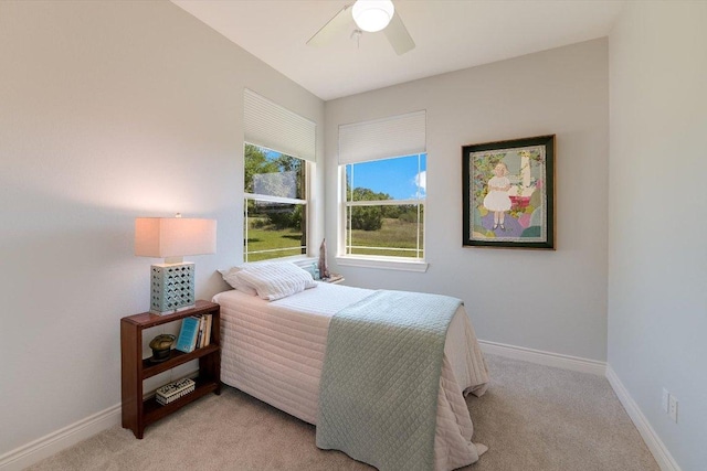 bedroom with light carpet, baseboards, and ceiling fan