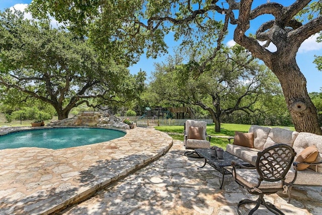 outdoor pool featuring an outdoor hangout area, a patio, and a playground