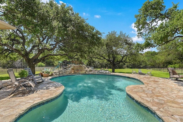 view of swimming pool with fence, a fenced in pool, a yard, and a patio