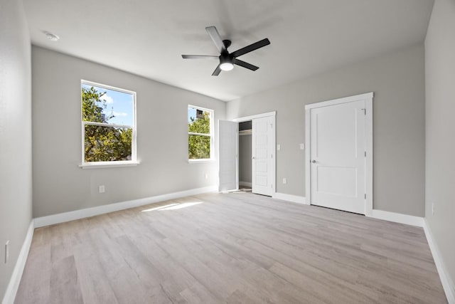 7 Harmony Ln, Wimberley, TX 78676 - unfurnished bedroom with wood finished floors and ceiling fan