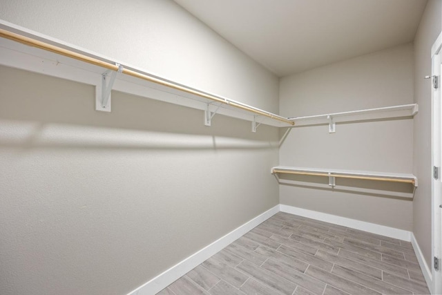 7 Harmony Ln, Wimberley, TX 78676 - walk in closet featuring wood finished floors