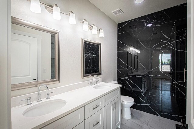 106 Passion Vine Rd, Dale, TX 78616 - bathroom featuring marble look tile flooring, double vanity, and a marble finish shower