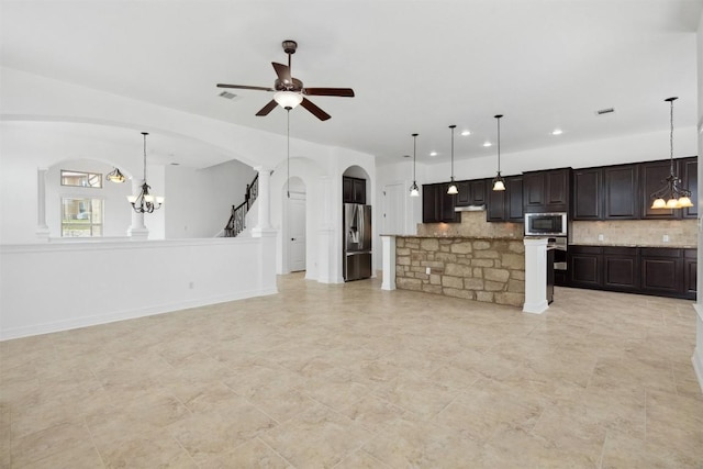 111 Antonio Way Unit 5A, Austin, TX 78734 - kitchen with stainless steel appliances, arched walkways, a chandelier, open floor plan, and recessed lighting