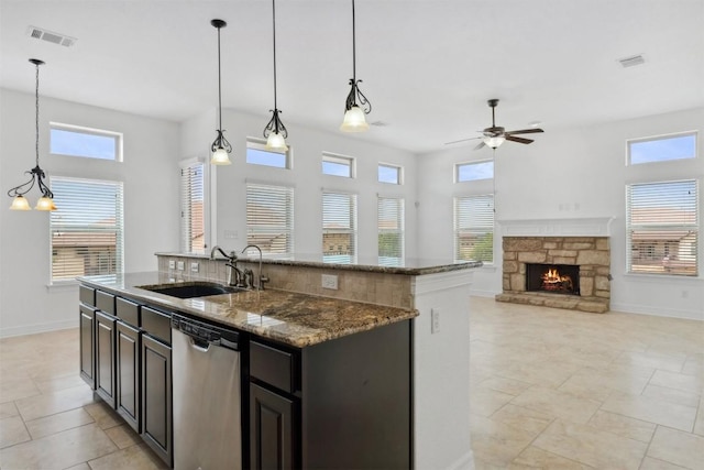 111 Antonio Way Unit 5A, Austin, TX 78734 - kitchen featuring stainless steel dishwasher, a ceiling fan, healthy amount of natural light, and a center island with sink