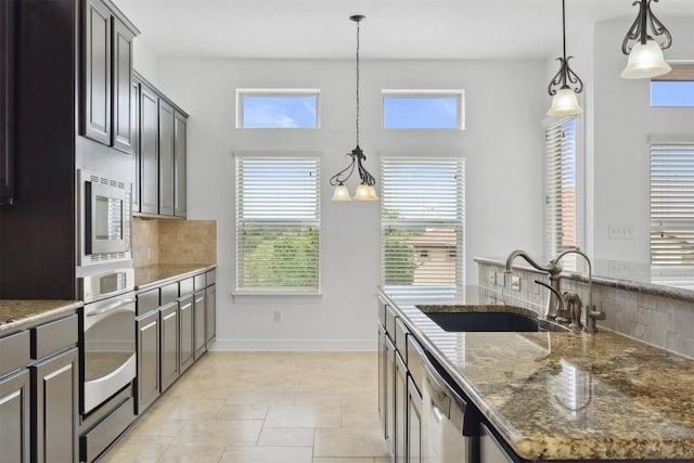 111 Antonio Way Unit 5A, Austin, TX 78734 - kitchen featuring appliances with stainless steel finishes, decorative backsplash, healthy amount of natural light, and a high ceiling