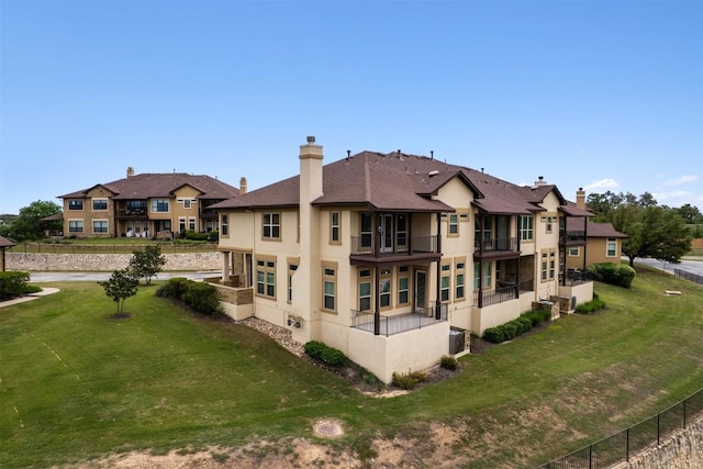 111 Antonio Way Unit 5A, Austin, TX 78734 - rear view of house featuring stucco siding, a balcony, a chimney, and a residential view