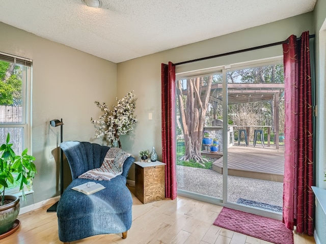 822 Hermitage Dr, Austin, TX 78753 - sitting room with wood finished floors and a textured ceiling
