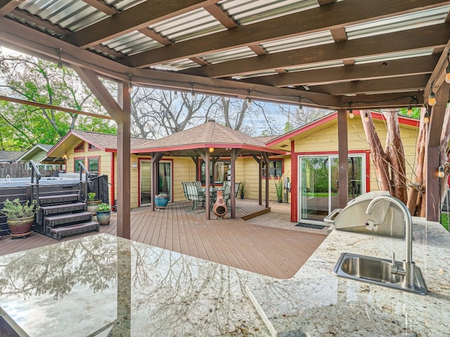 822 Hermitage Dr, Austin, TX 78753 - view of patio / terrace with a hot tub, a deck, an outdoor kitchen, and a sink