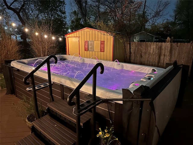 822 Hermitage Dr, Austin, TX 78753 - view of swimming pool with a hot tub, fence, a deck, an outdoor structure, and a storage unit