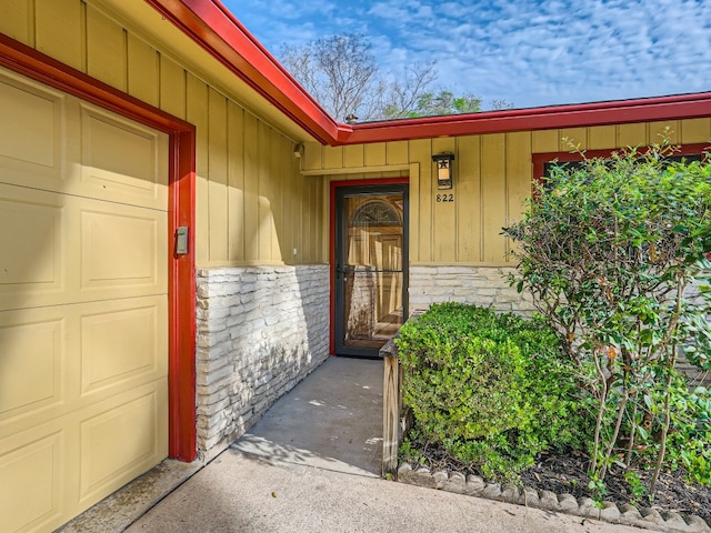 822 Hermitage Dr, Austin, TX 78753 - doorway to property featuring stone siding and board and batten siding