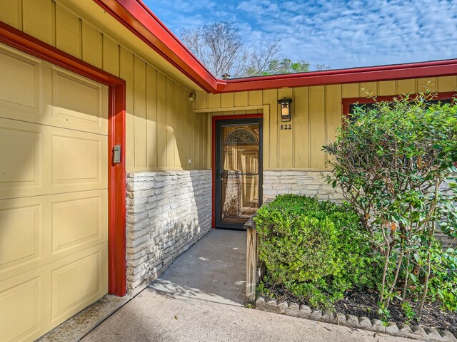 822 Hermitage Dr, Austin, TX 78753 - entrance to property with stone siding and board and batten siding