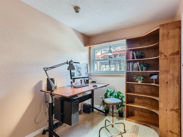 822 Hermitage Dr, Austin, TX 78753 - home office featuring a textured ceiling, wood finished floors, and a textured wall