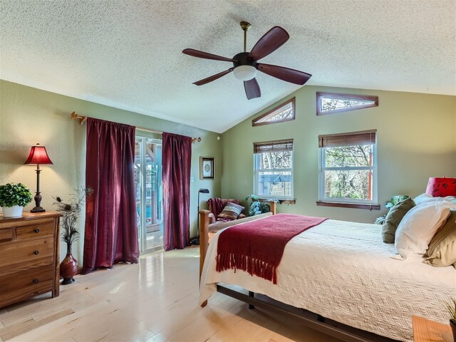 822 Hermitage Dr, Austin, TX 78753 - bedroom featuring wood finished floors, a textured ceiling, vaulted ceiling, and a ceiling fan