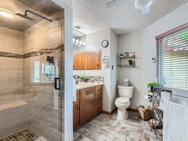 822 Hermitage Dr, Austin, TX 78753 - bathroom featuring a shower stall, healthy amount of natural light, a ceiling fan, and toilet