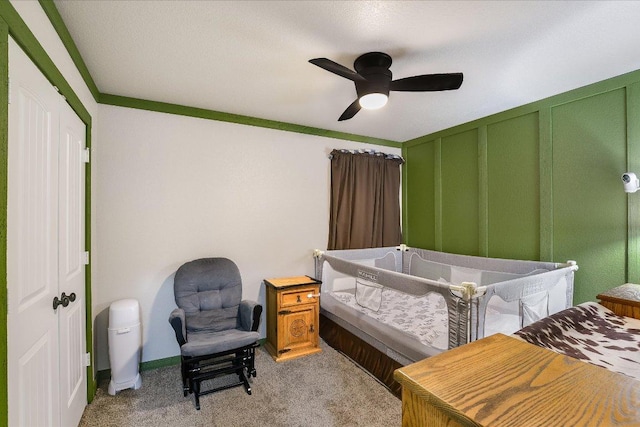 bedroom featuring light colored carpet and a ceiling fan