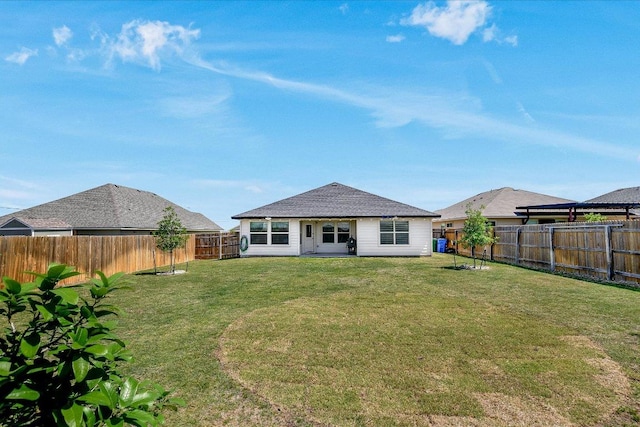 back of house featuring a lawn and a fenced backyard