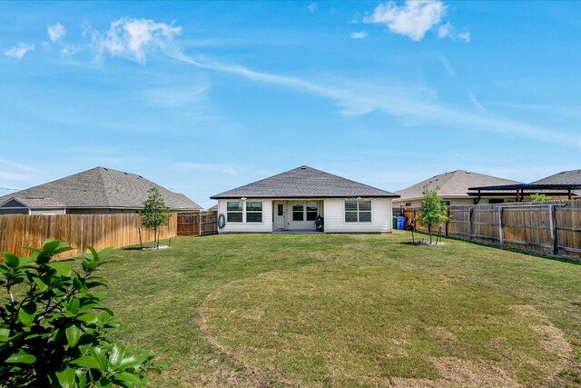 102 Reagor Dr, Taylor, TX 76574 - rear view of house featuring a fenced backyard and a shingled roof